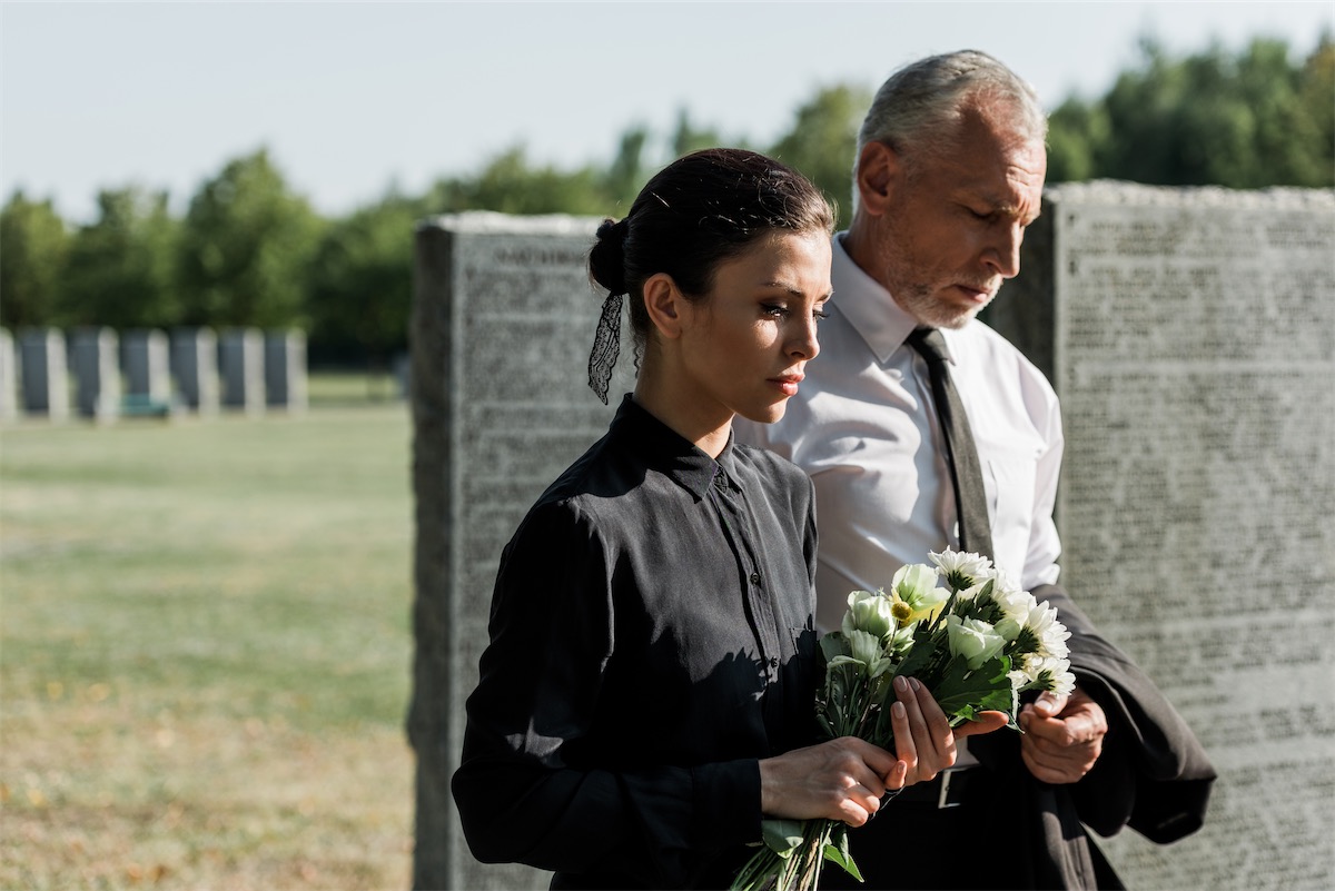 Two sad people at funeral. iFama offers accounting and tax consulting services.