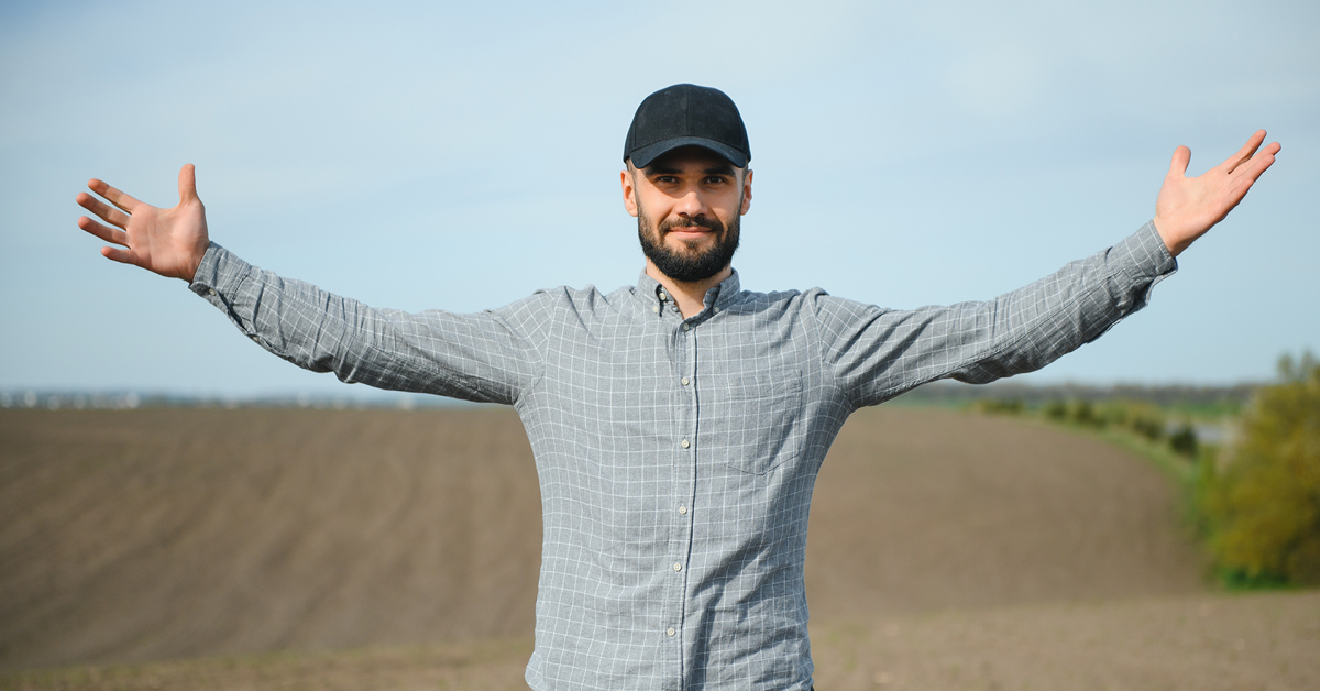 Topper Image for iFama article farmer with cap standing with back to open field with stretched out arms